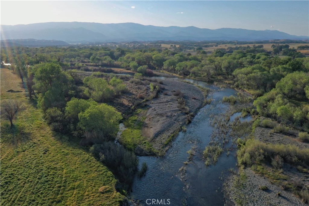 15385 Weston Road Corning, CA 96021 - Photo 8 of 75 an aerial view of green landscape with trees houses and mountain view
