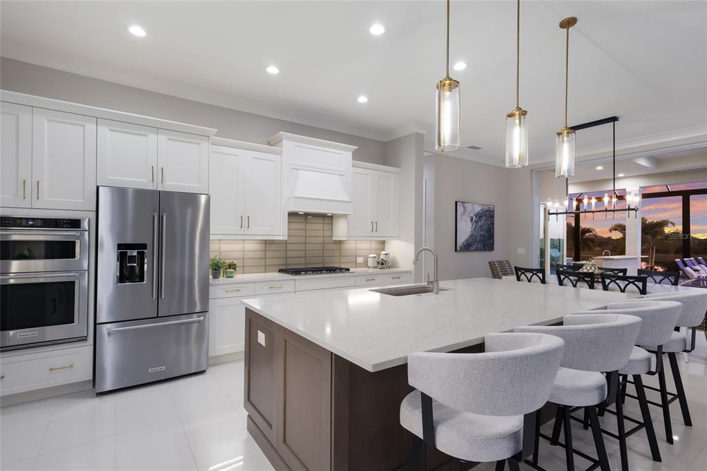 7923 Bowspirit Way Lakewood Ranch, FL 34202 - Photo 12 of 82 a kitchen with stainless steel appliances granite countertop a sink a stove a refrigerator a center island a stove and a center island