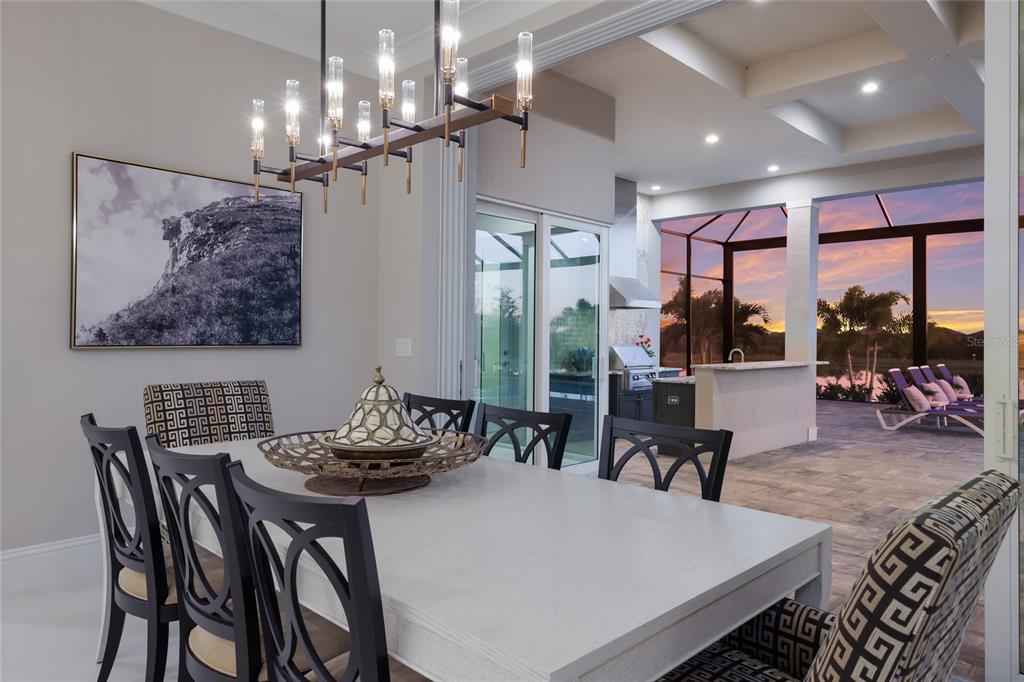 7923 Bowspirit Way Lakewood Ranch, FL 34202 - Photo 22 of 82 a view of a dining room with furniture wooden floor and chandelier