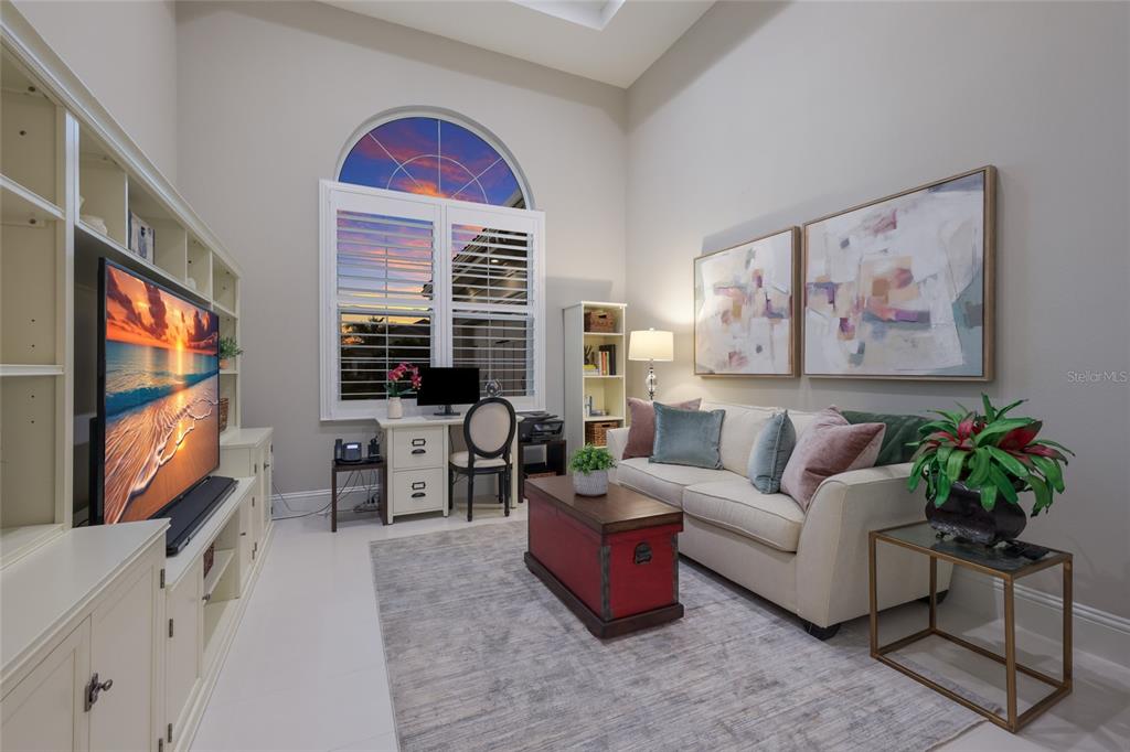 7923 Bowspirit Way Lakewood Ranch, FL 34202 - Photo 26 of 82 a living room with furniture a flat screen tv and a large window