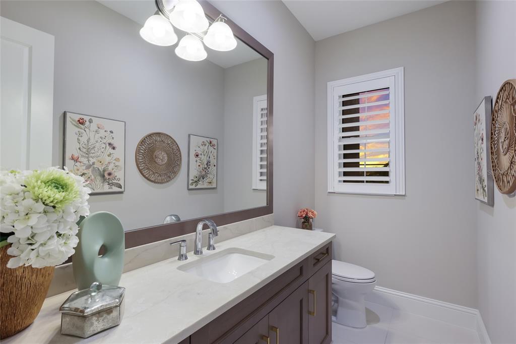 7923 Bowspirit Way Lakewood Ranch, FL 34202 - Photo 28 of 82 a bathroom with a toilet a sink and a mirror