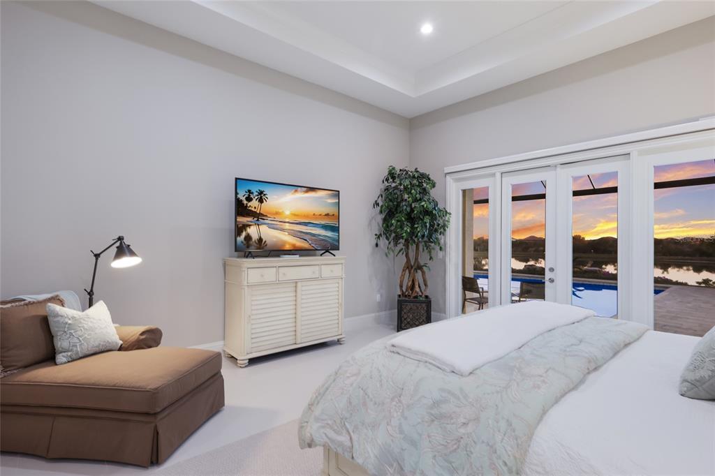 7923 Bowspirit Way Lakewood Ranch, FL 34202 - Photo 30 of 82 a bedroom with a bed and a flat screen tv