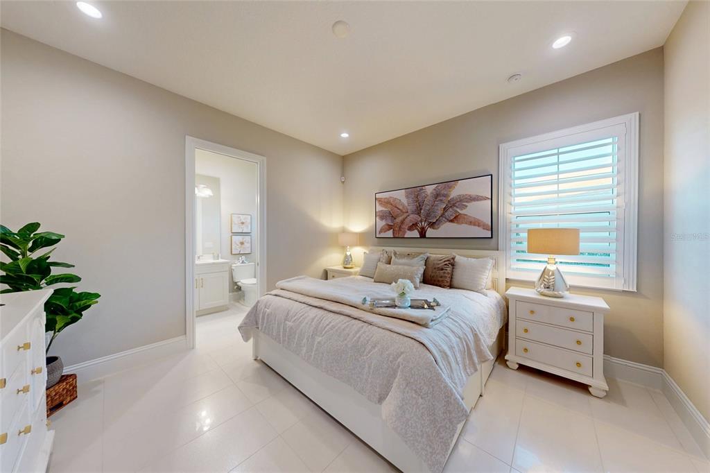 7923 Bowspirit Way Lakewood Ranch, FL 34202 - Photo 42 of 82 a bedroom with a bed a potted plant and a window