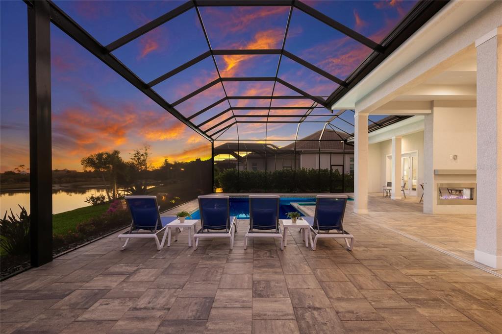 7923 Bowspirit Way Lakewood Ranch, FL 34202 - Photo 50 of 82 a view of a patio with a table and chairs under an umbrella
