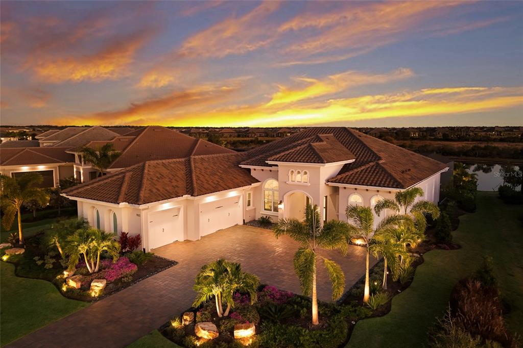 7923 Bowspirit Way Lakewood Ranch, FL 34202 - Photo 59 of 82 a view of a patio with table and chairs under an umbrella