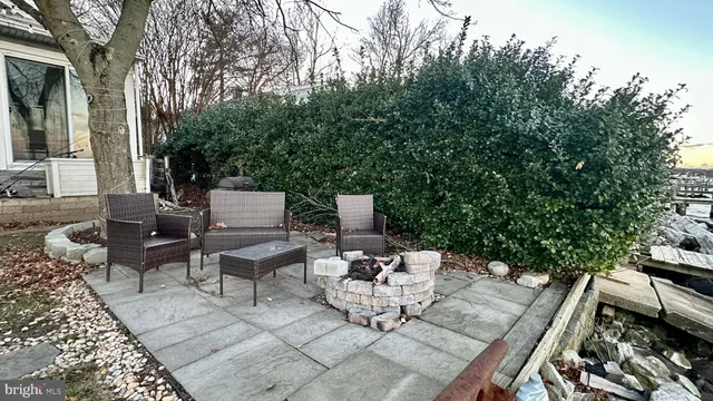 a front view of a house with yard and trees around