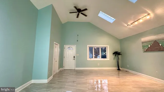 a view of a room with wooden floor and windows