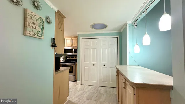 a kitchen with stainless steel appliances granite countertop a refrigerator a stove and a sink