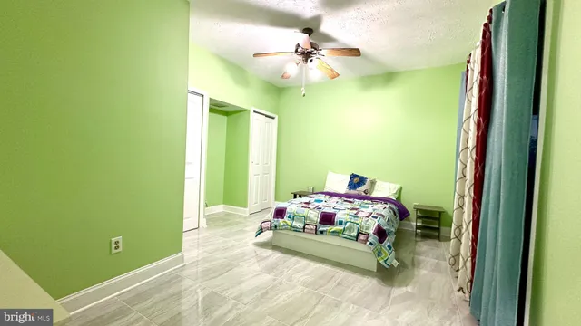 a bedroom with a bed and a painting on the wall