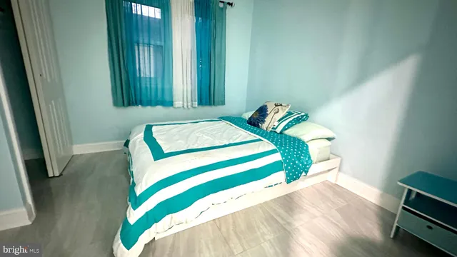 a bed sitting in a bedroom next to a window