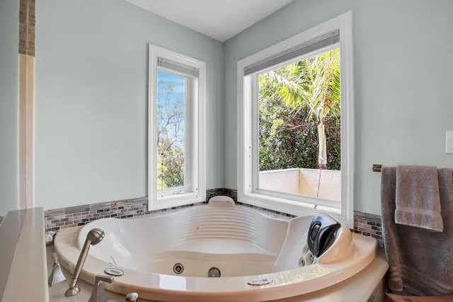 a living room with a bed and a large window