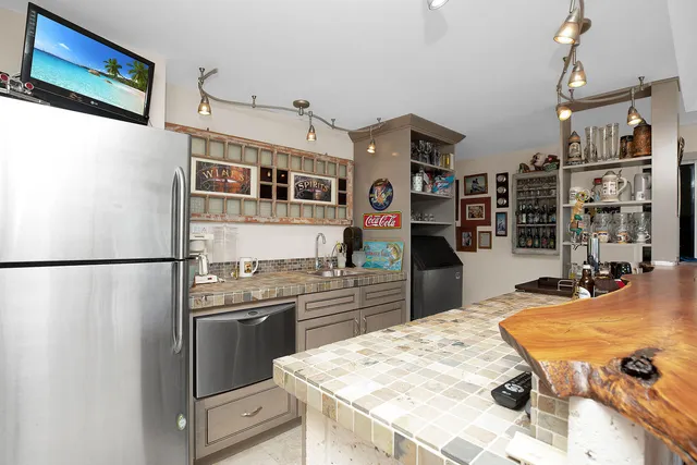a dining room with furniture and a potted plant