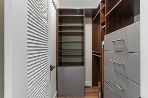 a view of walk in closet with empty racks