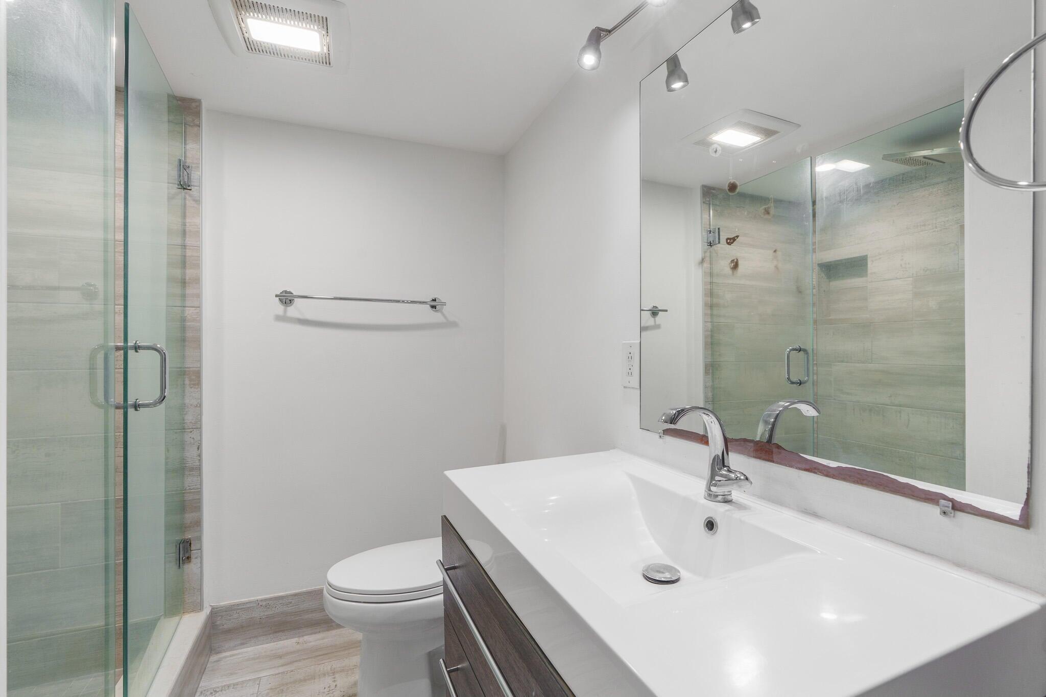 951 De Soto Road, Unit 130 Boca Raton, FL 33432 - Photo 15 of 38 a bathroom with a sink a toilet and shower