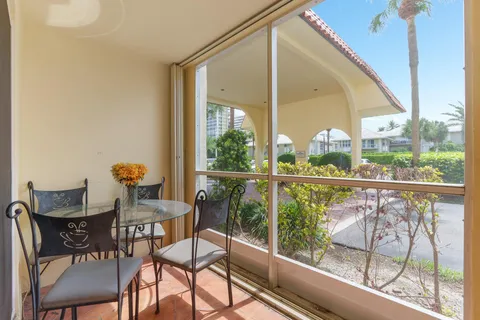 a view of a chairs and table in the balcony