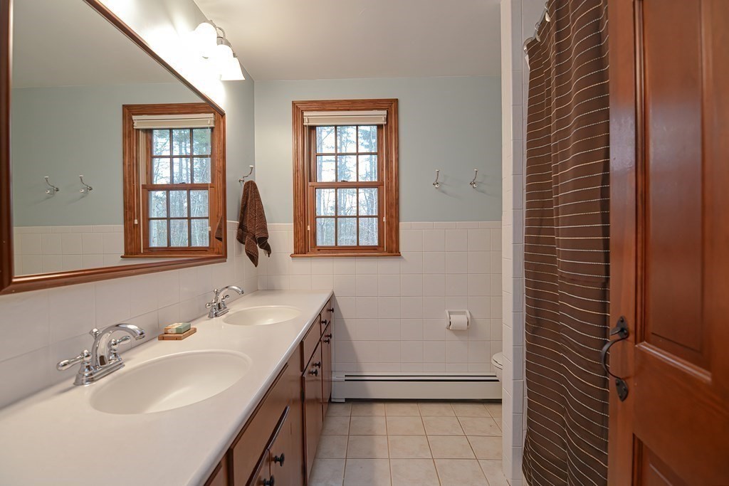 154 Red Acre Road Stow, MA 01775 - Photo 23 of 35 a bathroom with a sink and a mirror