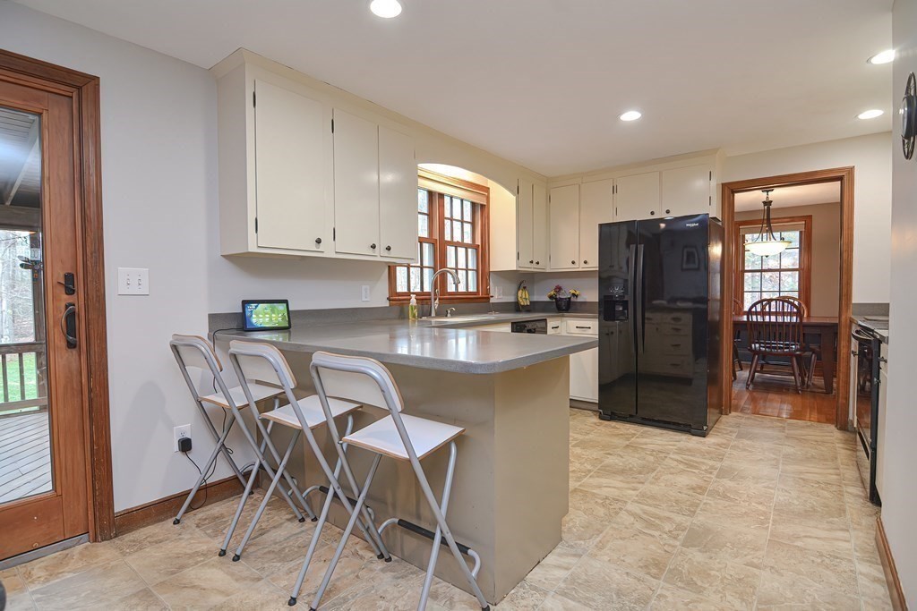 154 Red Acre Road Stow, MA 01775 - Photo 8 of 35 a kitchen with stainless steel appliances a refrigerator and a stove top oven