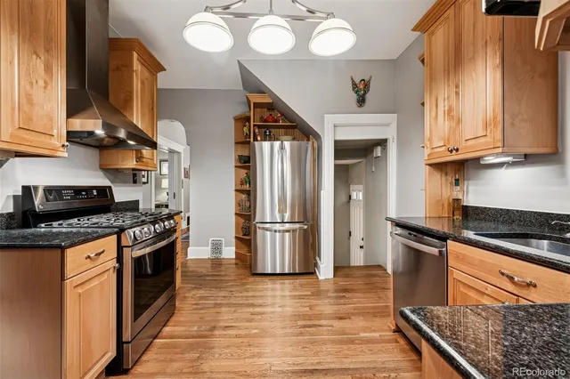 a kitchen with stainless steel appliances granite countertop a stove and a refrigerator