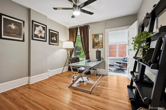 a living room with furniture a window and a flat screen tv