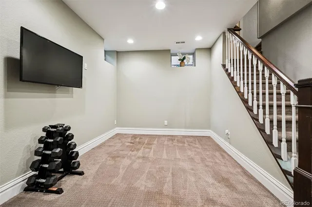 a view of a livingroom with wooden floor and stairs