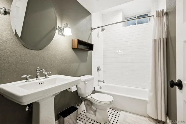 a bathroom with a sink toilet a shower and a mirror