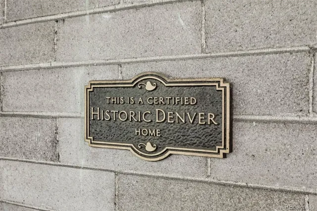a black and white wall with a sign on it