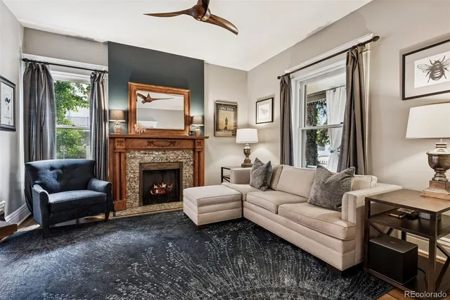a living room with furniture and a fireplace