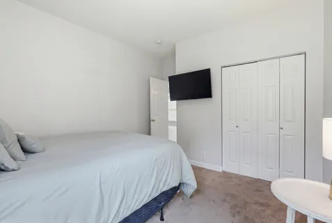 a living room with furniture ceiling fan and a window