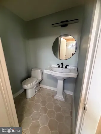 a bathroom with a sink a mirror and a toilet