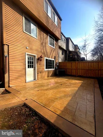 a view of a house with a wooden fence