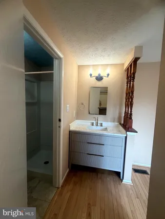 a bathroom with a double vanity sink and mirror