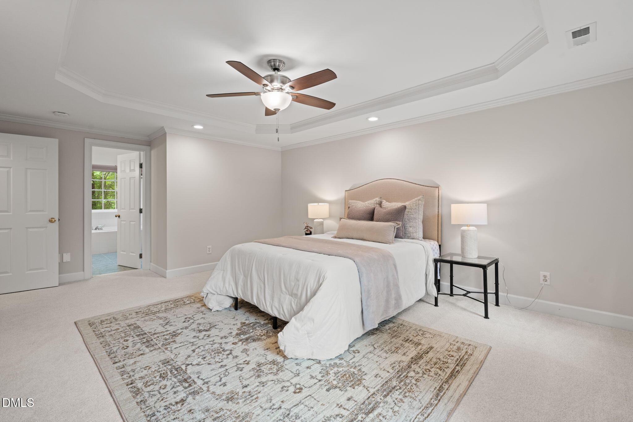 5809 Stone Spring Road Raleigh, NC 27613 - Photo 22 of 54 a bedroom with a bed and a chandelier