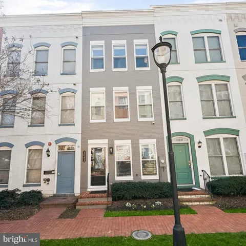 a pathway of a house with a yard
