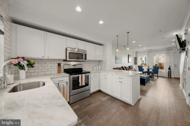 a kitchen with sink a microwave and cabinets