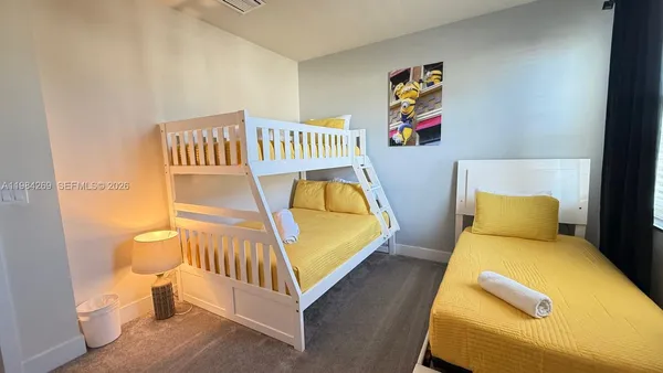 a bedroom with a bed and lamp