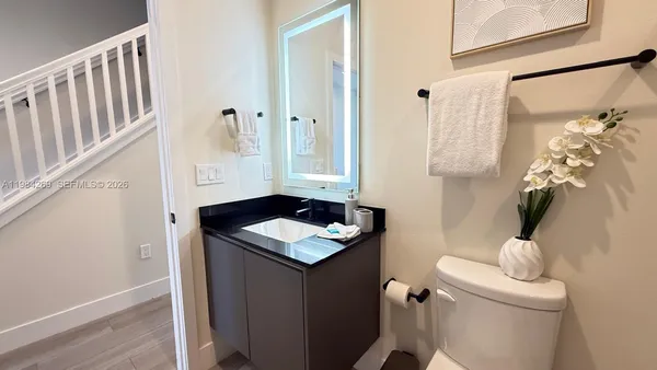 a bathroom with a sink toilet and shower