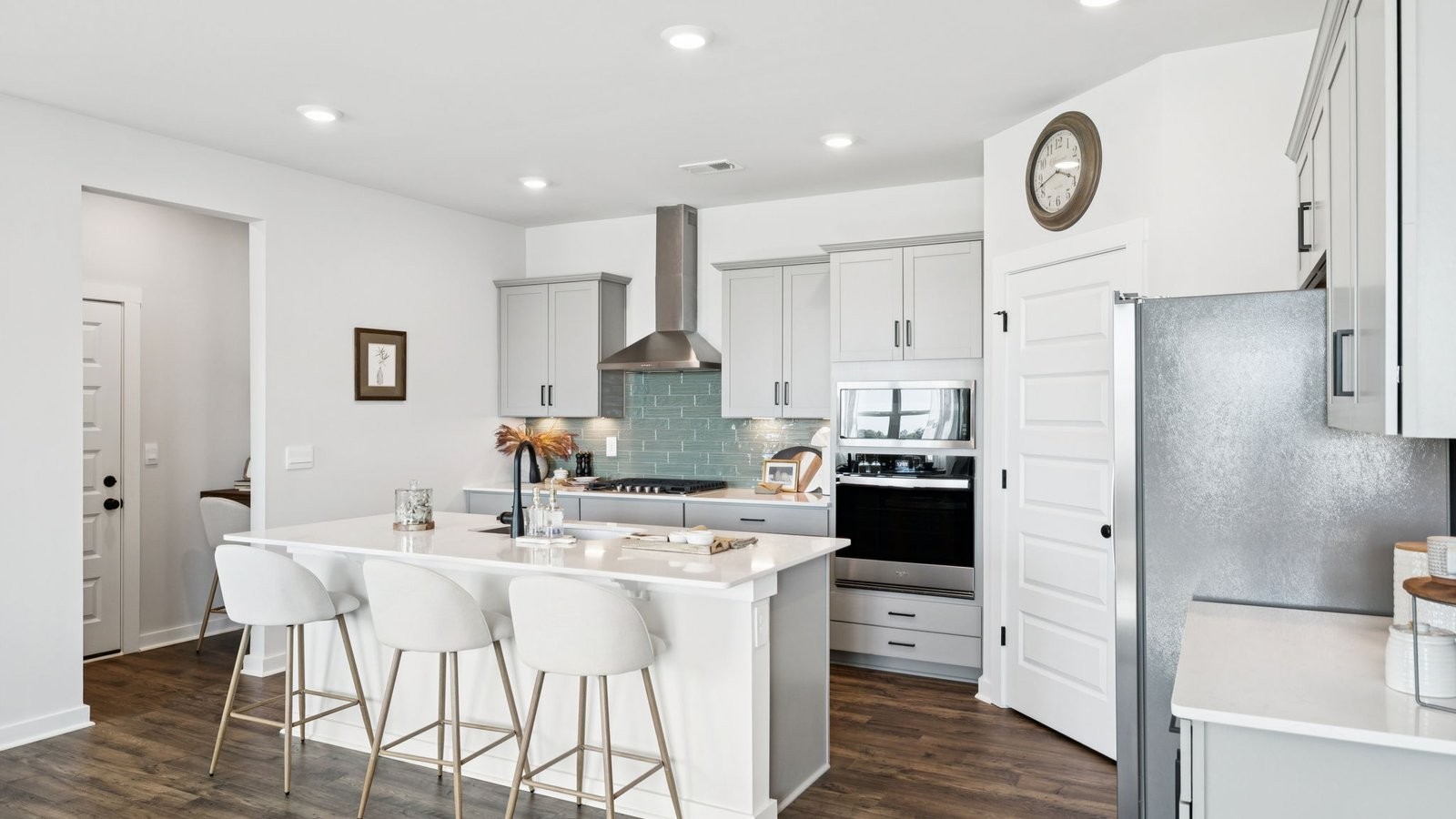 309 Harvest Point Boulevard Spring Hill, TN 37174 - Photo 17 of 46 a kitchen with a refrigerator a sink dishwasher a dining table and chairs with wooden floor