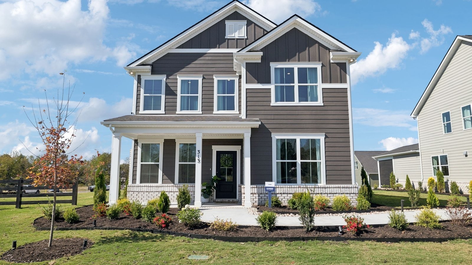 309 Harvest Point Boulevard Spring Hill, TN 37174 - Photo 4 of 46 a front view of a house with a yard and potted plants