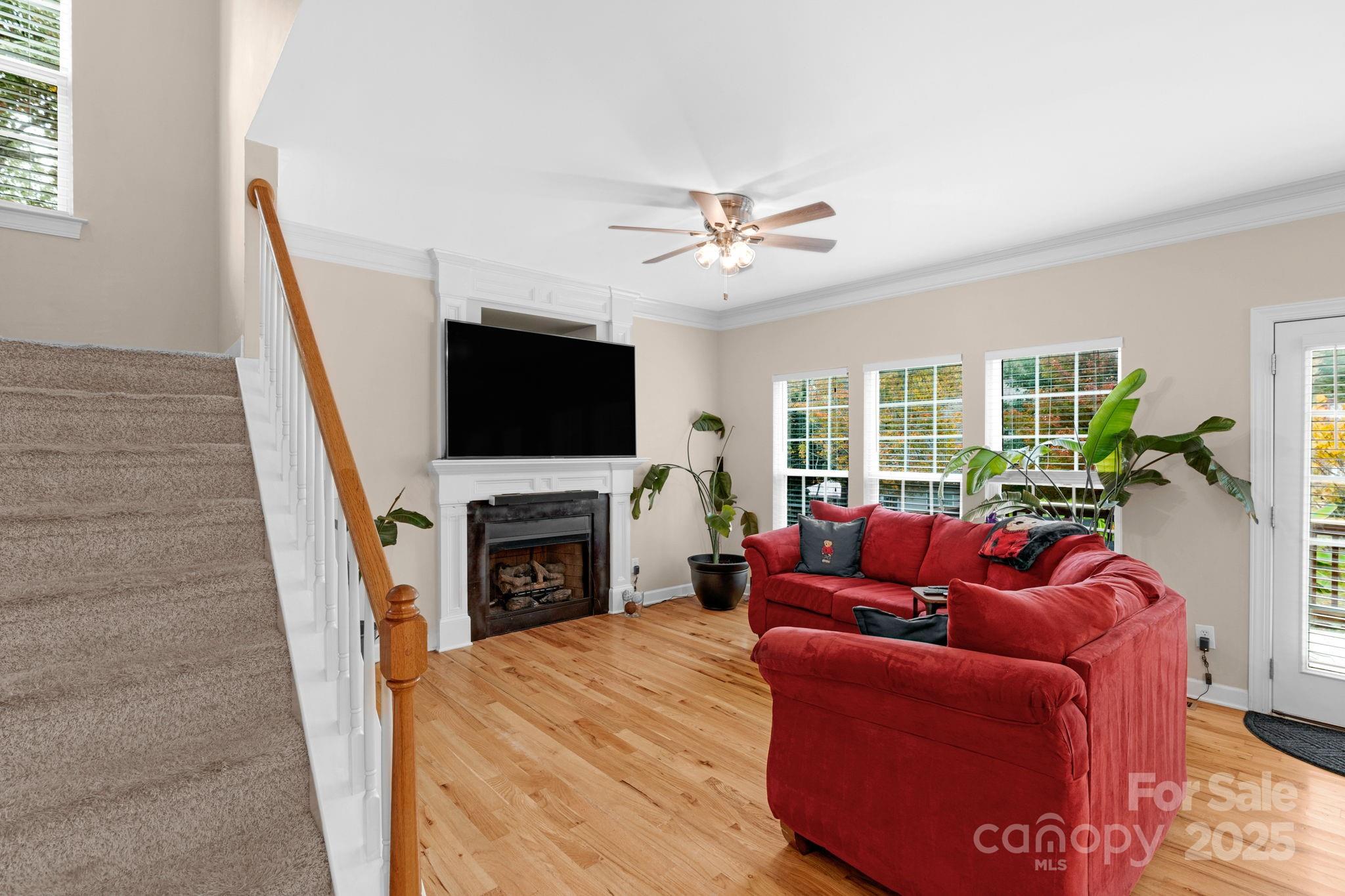 2805 Cross Tie Lane Matthews, NC 28105 - Photo 15 of 42 a living room with furniture a fireplace and a flat screen tv