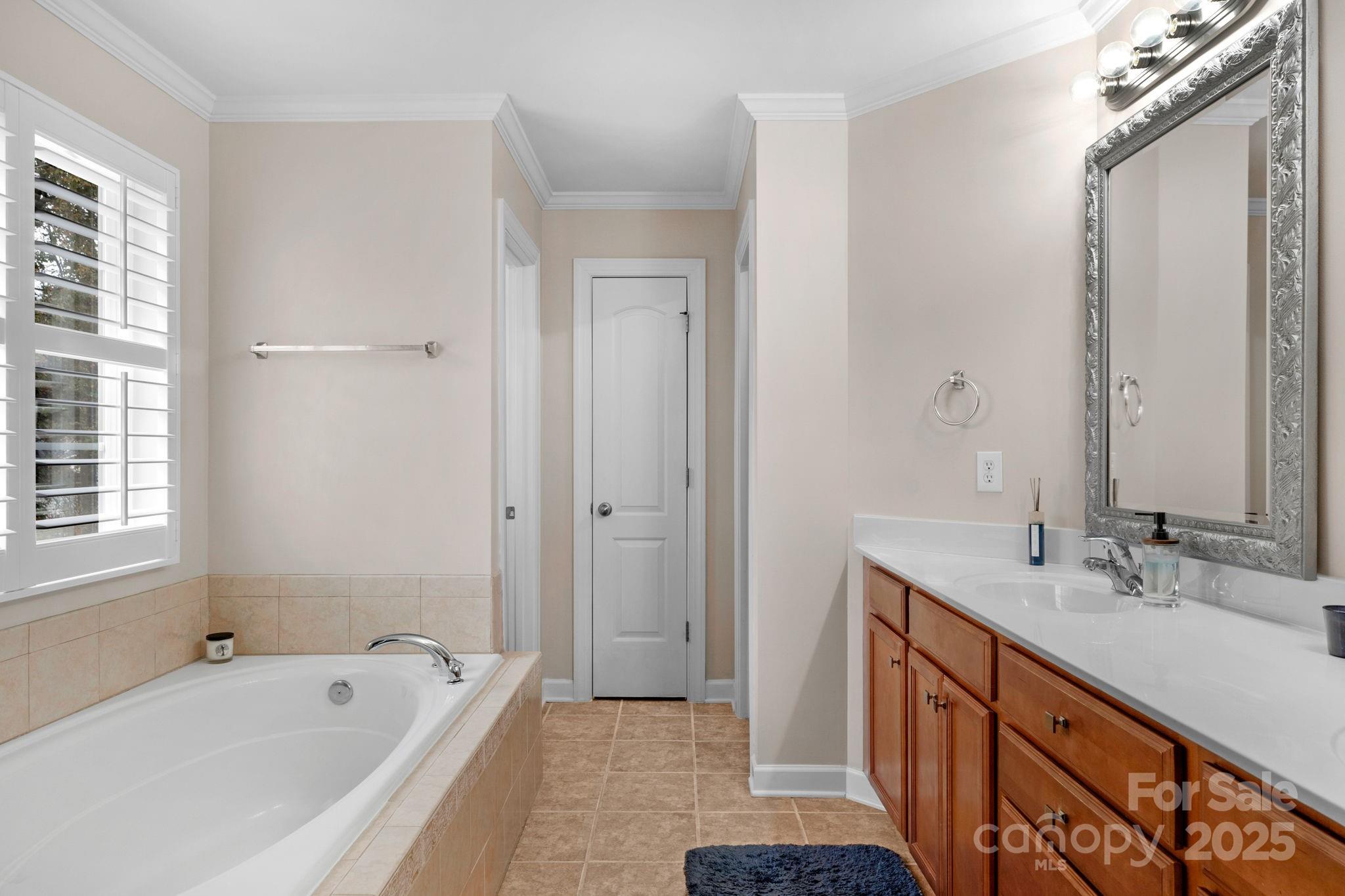 2805 Cross Tie Lane Matthews, NC 28105 - Photo 22 of 42 a bathroom with 2 sink tub and a mirror