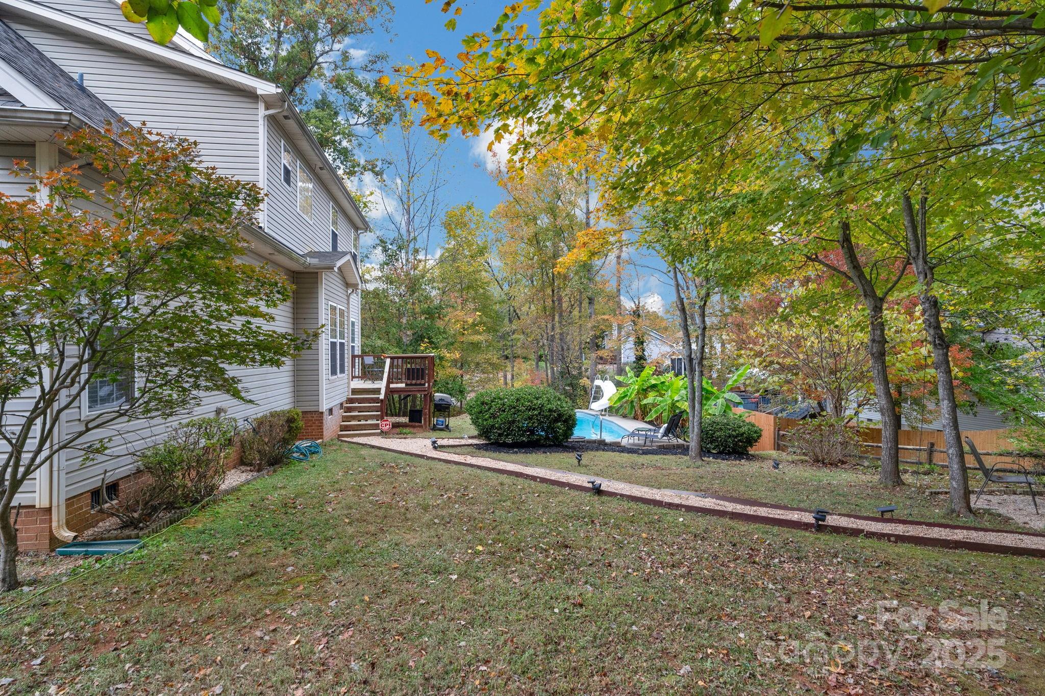 2805 Cross Tie Lane Matthews, NC 28105 - Photo 39 of 42 a view of a house with potted plants and large trees