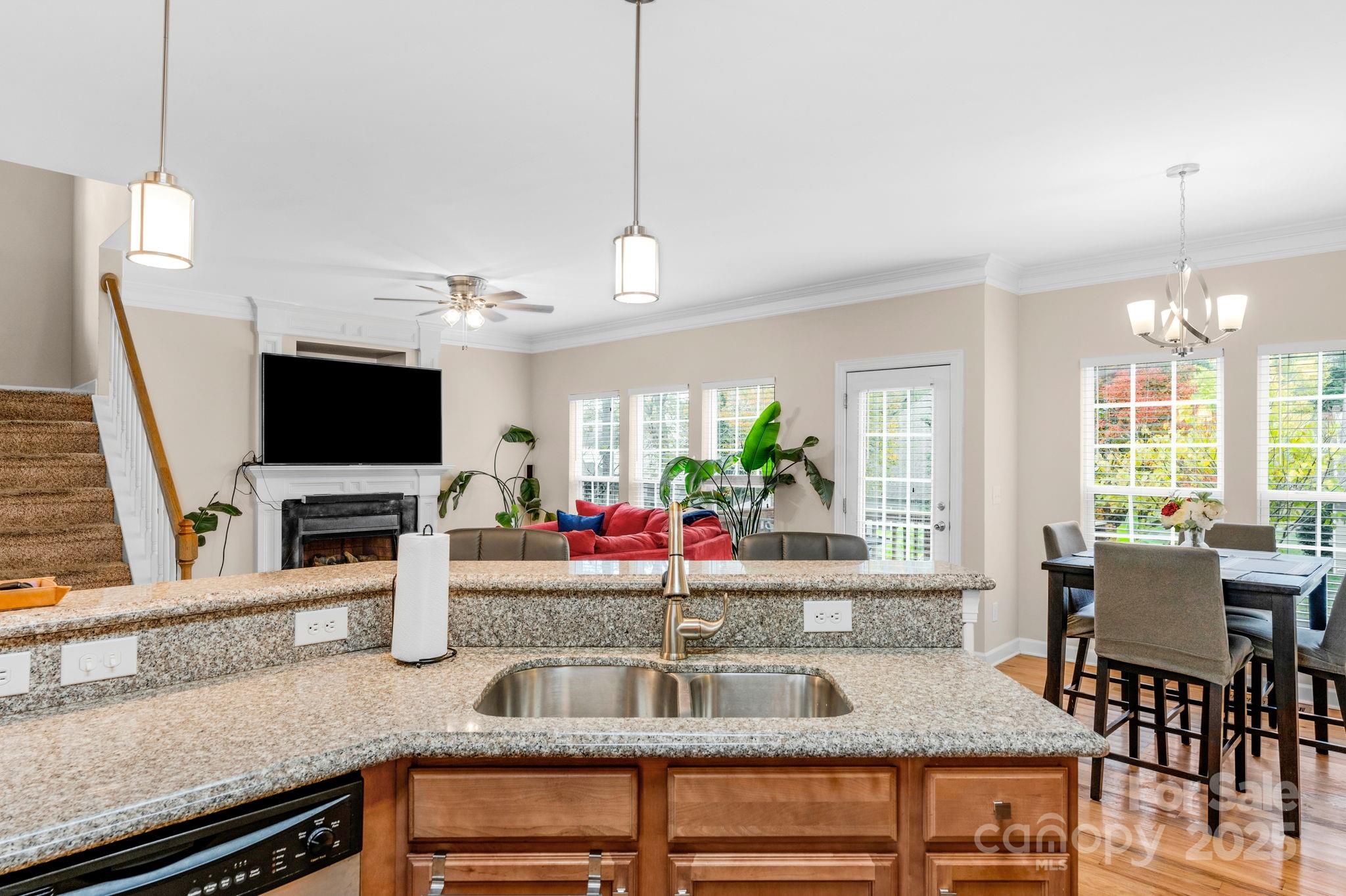 2805 Cross Tie Lane Matthews, NC 28105 - Photo 10 of 42 a kitchen with granite countertop a table and chairs in it