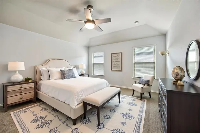 a bedroom with bed and a chandelier