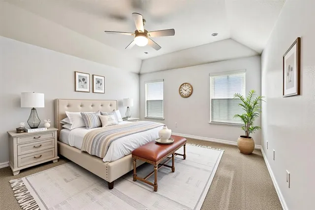 a spacious bedroom with a bed and a chandelier