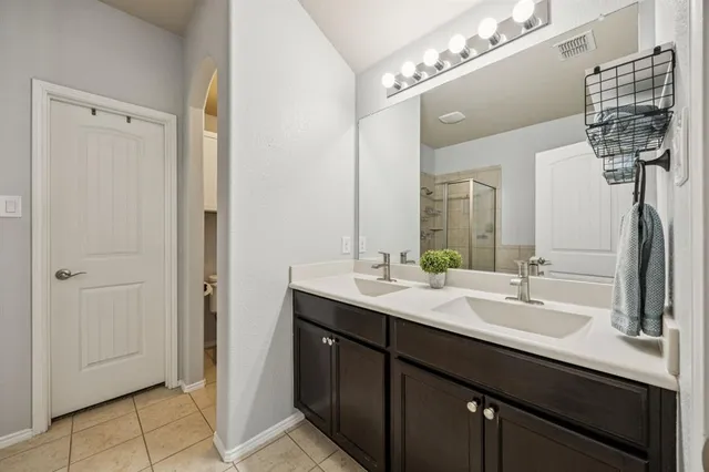 a bathroom with a double vanity sink a and mirror