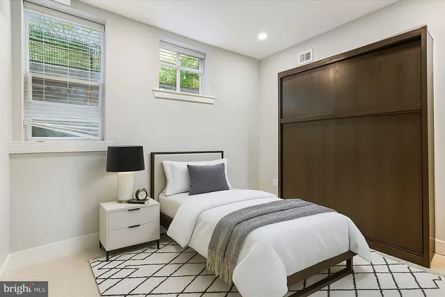 a bedroom with a bed and a window