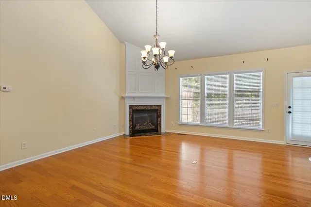 a large kitchen with kitchen island a sink a stove and a refrigerator with wooden floor