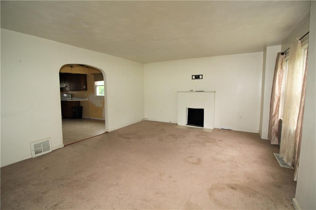 1456 Rte 481 Charleroi, PA 15022 - Photo 14 of 25 The Living Room has Carpeting, Two Windows, a Decorative Fireplace, Cable Hookup, and TV Mount.