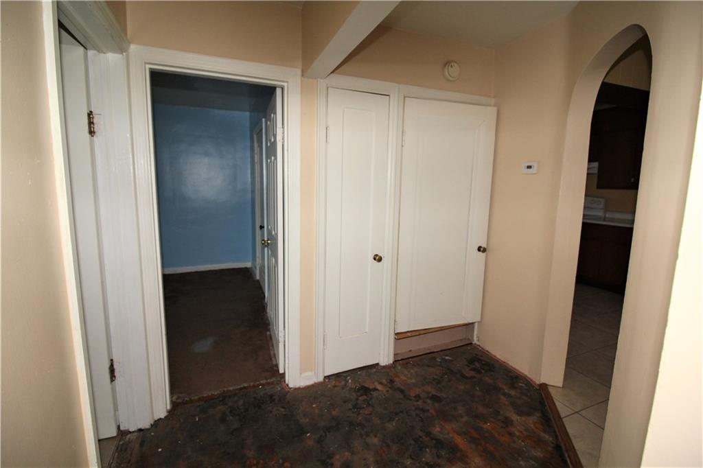 1456 Rte 481 Charleroi, PA 15022 - Photo 21 of 25 Detail Shot of the Main Hallway. Taken From Master Bedroom Doorway, to the Left is a Shelved Closet, then the Full Main Bath, Second Bedroom, Second Closet, and Steps to the Upper Level.