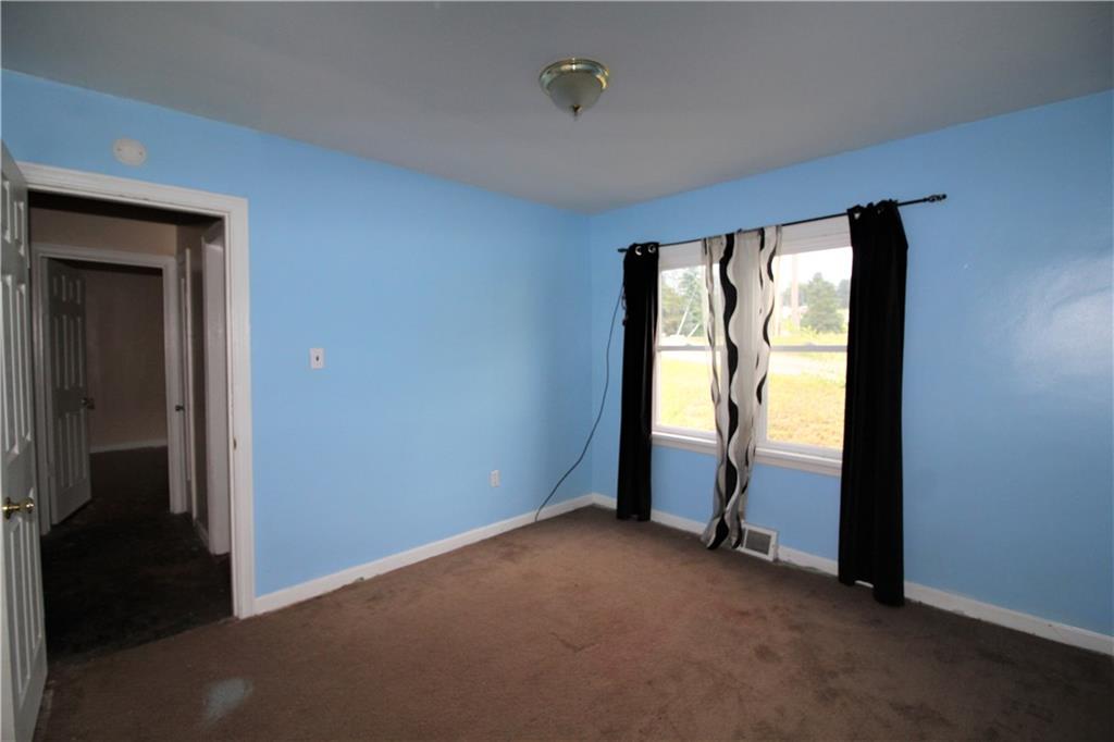 1456 Rte 481 Charleroi, PA 15022 - Photo 4 of 25 One of the 2 Desirable First Floor Bedrooms with Wooden Trim Baseboard Detail, Carpeting, and Overhead Light.
